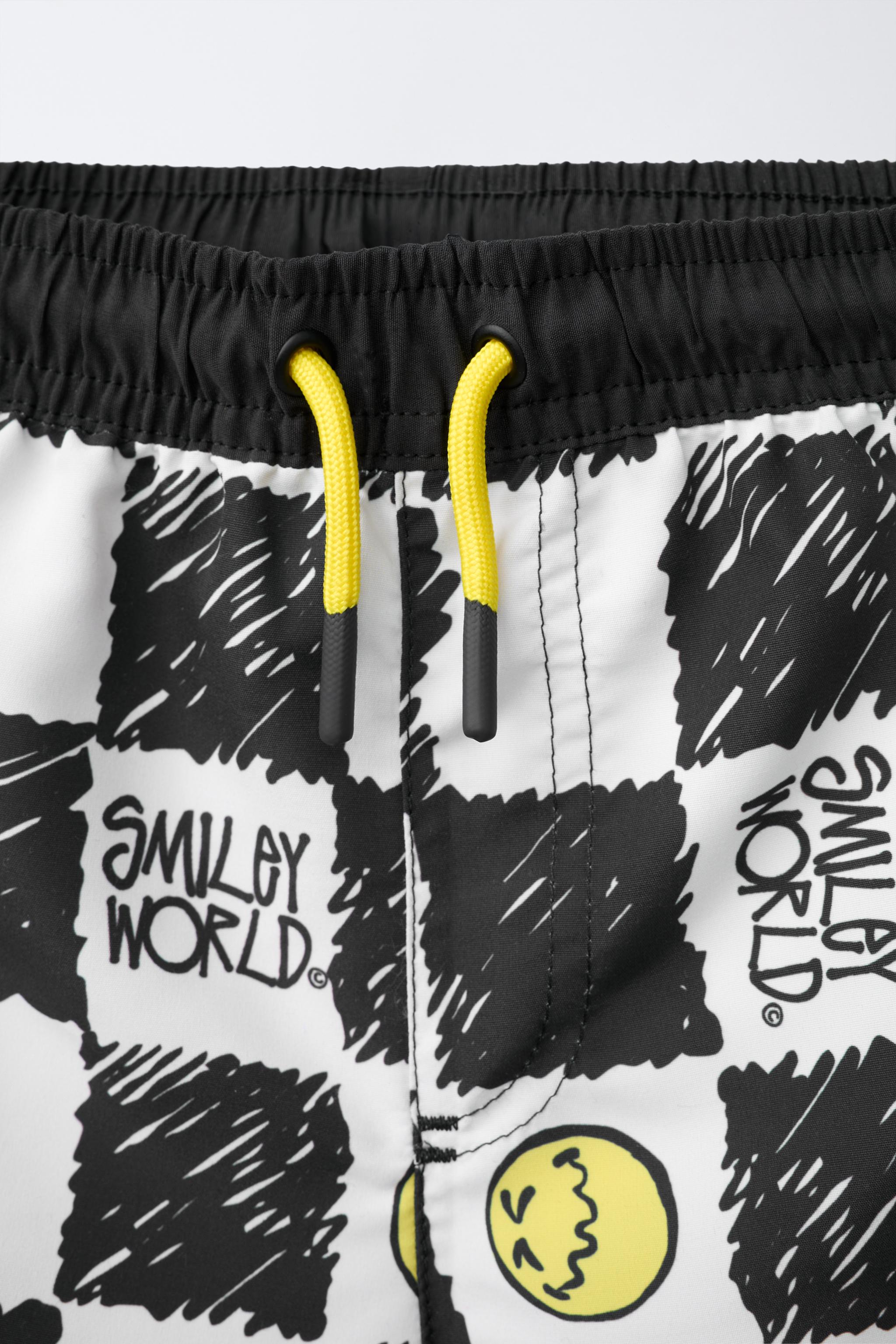 6-14 ANS/ SHORT DE BAIN DAMIER SMILEYWORLD ®